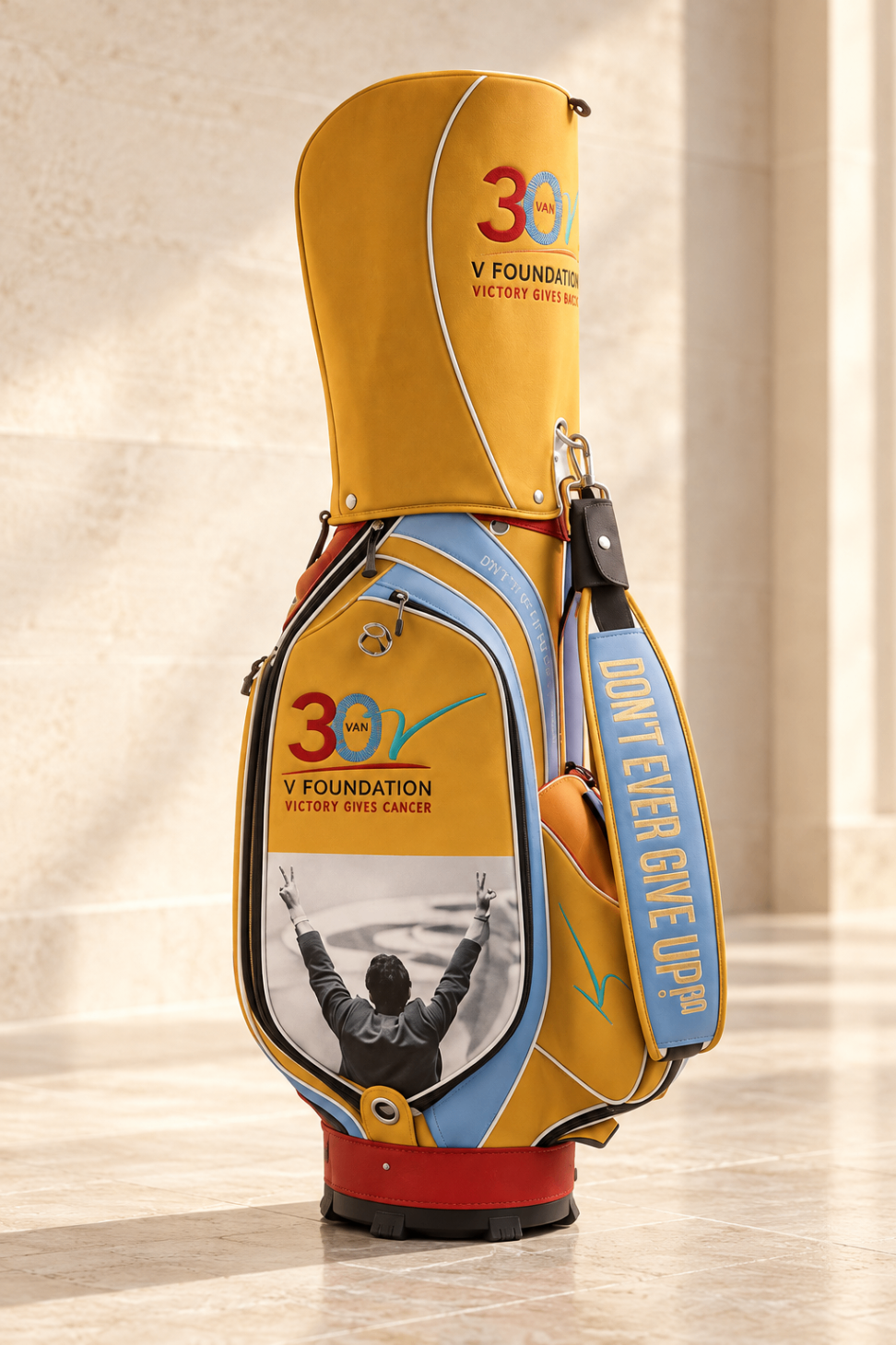 Jimmy V Foundation charity auction staff bag — yellow, blue and red with embroidered crest